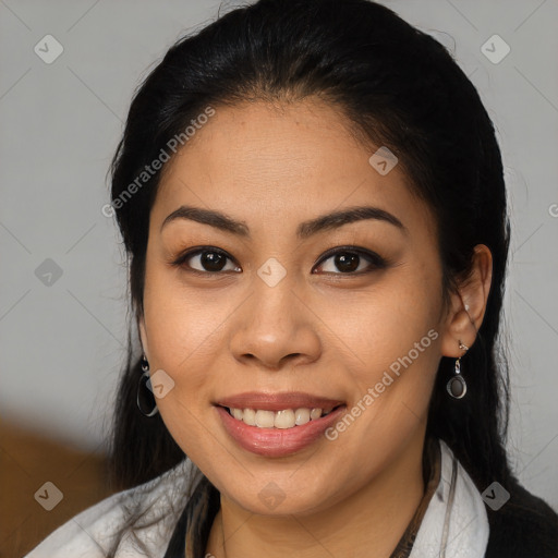 Joyful latino young-adult female with medium  brown hair and brown eyes