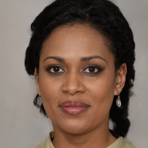 Joyful black young-adult female with medium  black hair and brown eyes
