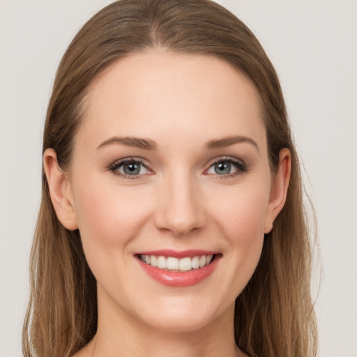 Joyful white young-adult female with long  brown hair and grey eyes