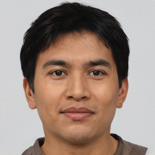 Joyful asian young-adult male with short  black hair and brown eyes