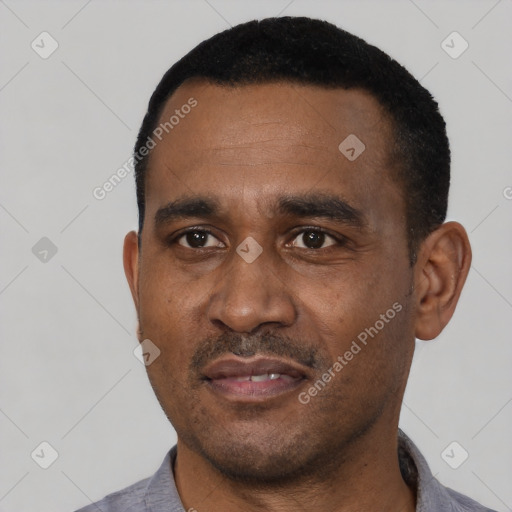 Joyful black adult male with short  black hair and brown eyes