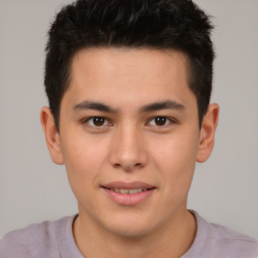 Joyful asian young-adult male with short  brown hair and brown eyes