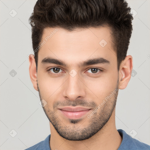 Joyful white young-adult male with short  brown hair and brown eyes