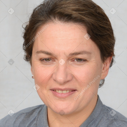 Joyful white adult female with medium  brown hair and blue eyes