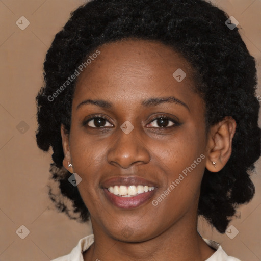 Joyful black young-adult female with short  black hair and brown eyes