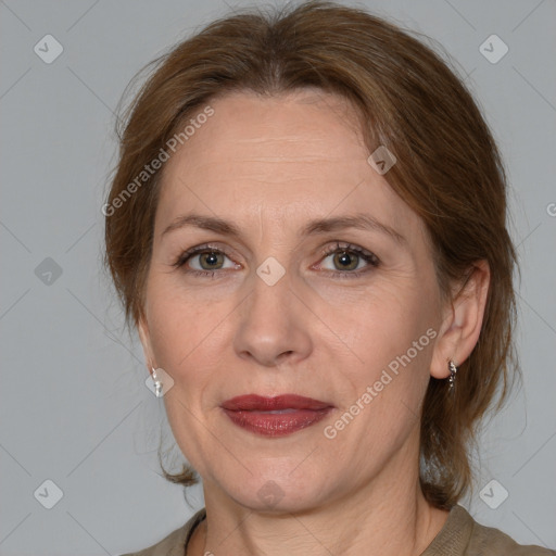 Joyful white adult female with medium  brown hair and grey eyes