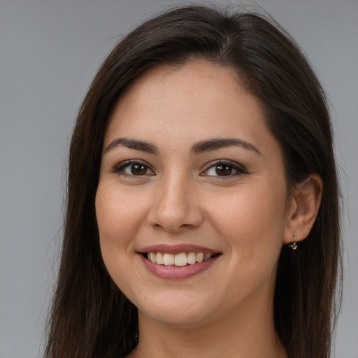 Joyful white young-adult female with long  brown hair and brown eyes