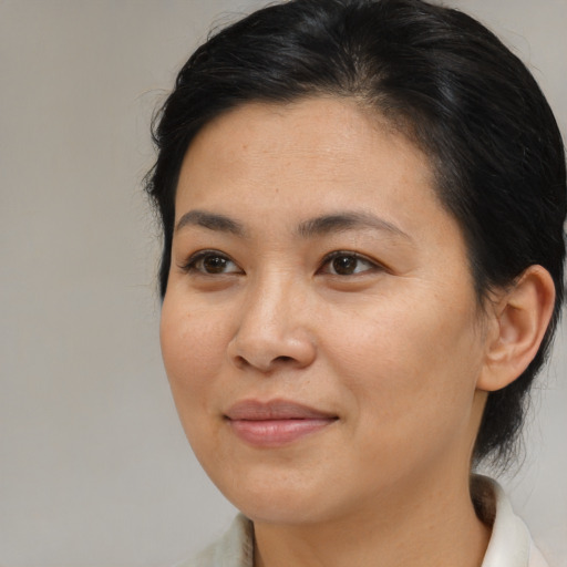 Joyful asian young-adult female with medium  brown hair and brown eyes