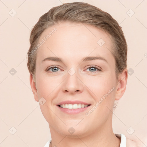 Joyful white young-adult female with short  brown hair and grey eyes