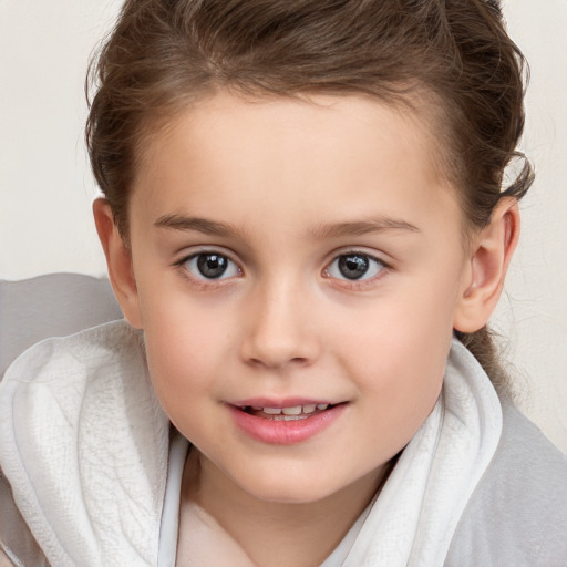 Joyful white child female with short  brown hair and brown eyes