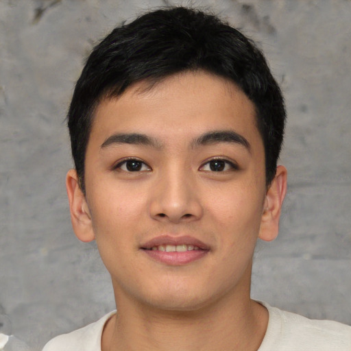 Joyful asian young-adult male with short  black hair and brown eyes