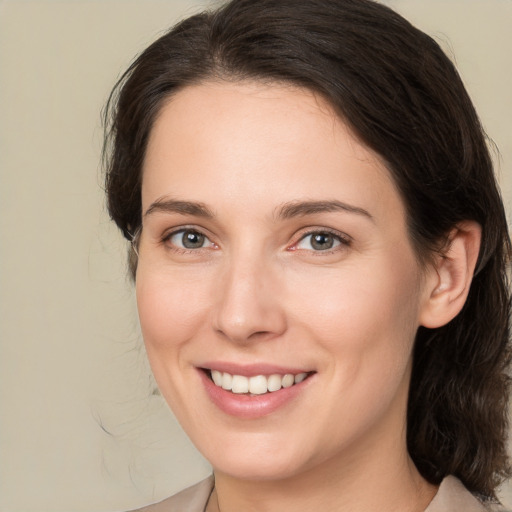 Joyful white young-adult female with medium  brown hair and brown eyes