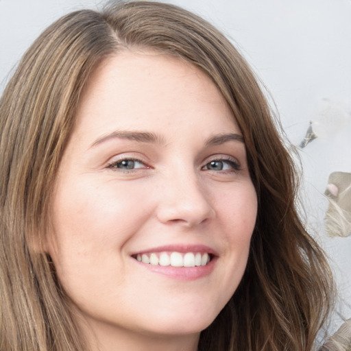 Joyful white young-adult female with long  brown hair and blue eyes