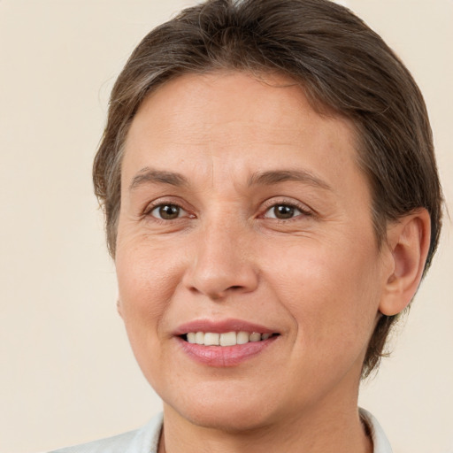 Joyful white adult female with short  brown hair and brown eyes