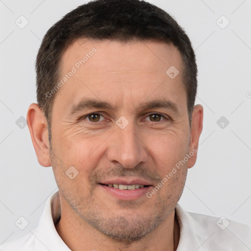 Joyful white adult male with short  brown hair and brown eyes