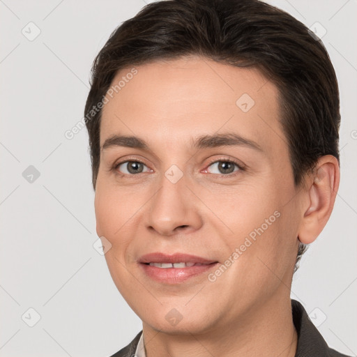 Joyful white adult male with short  brown hair and grey eyes