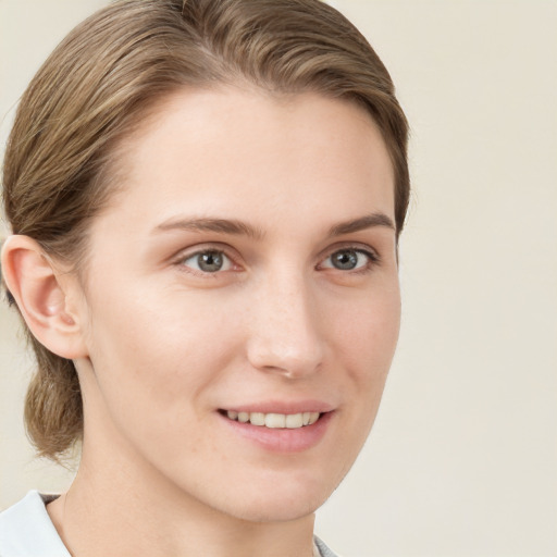 Joyful white young-adult female with medium  brown hair and blue eyes