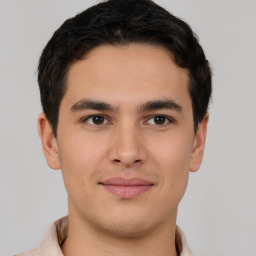 Joyful latino young-adult male with short  brown hair and brown eyes