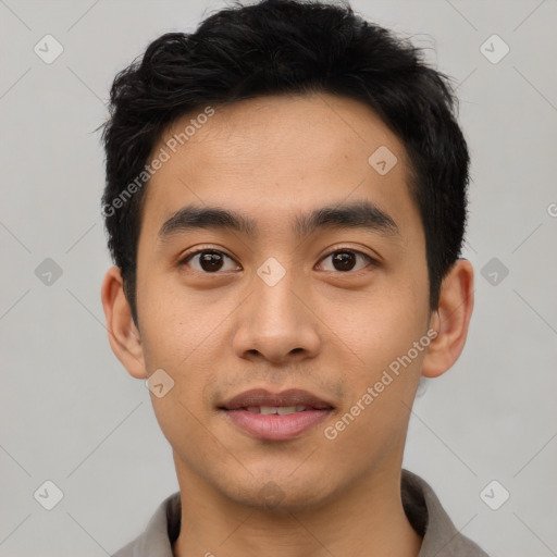 Joyful asian young-adult male with short  black hair and brown eyes