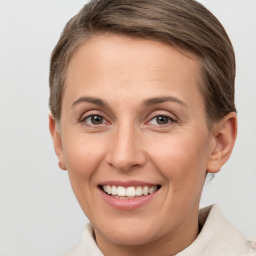 Joyful white young-adult female with short  brown hair and grey eyes