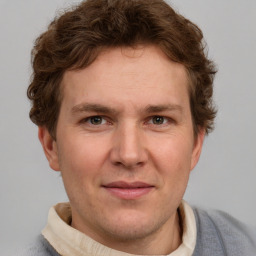 Joyful white adult male with short  brown hair and grey eyes