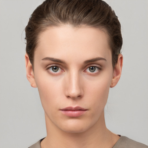 Neutral white young-adult female with short  brown hair and brown eyes