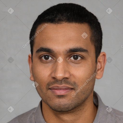 Joyful latino young-adult male with short  black hair and brown eyes