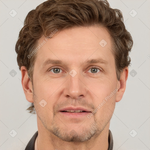 Joyful white adult male with short  brown hair and grey eyes