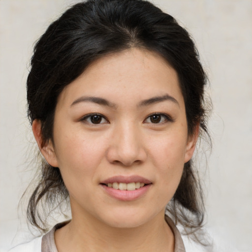 Joyful asian young-adult female with medium  brown hair and brown eyes