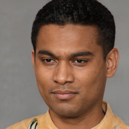 Joyful latino young-adult male with short  black hair and brown eyes