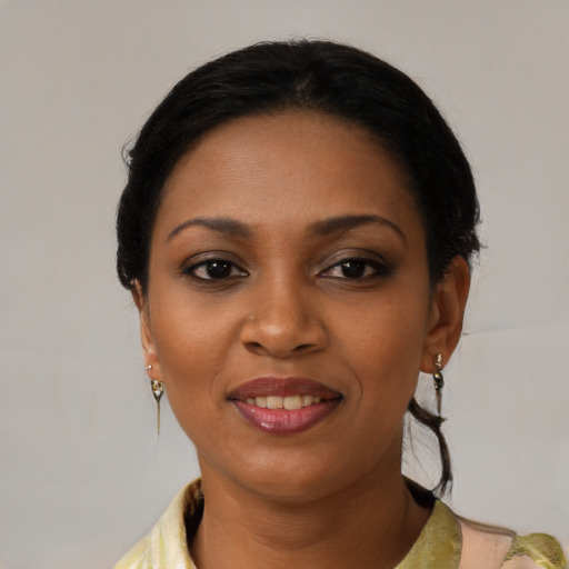 Joyful black young-adult female with medium  black hair and brown eyes