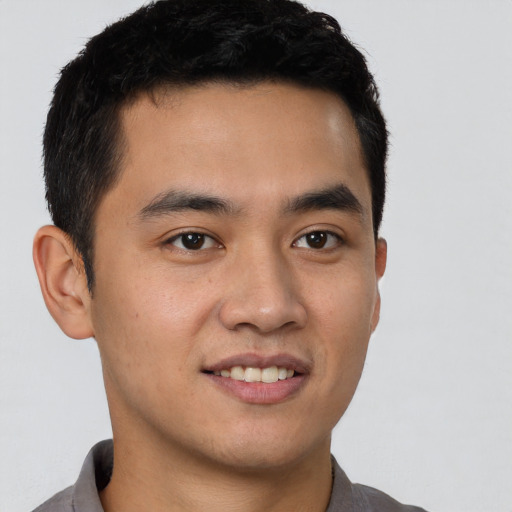 Joyful latino young-adult male with short  brown hair and brown eyes