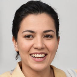 Joyful latino young-adult female with medium  brown hair and brown eyes