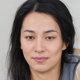 Joyful asian young-adult female with long  brown hair and brown eyes