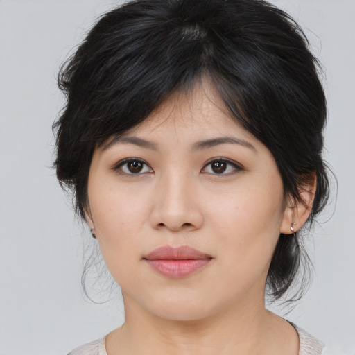 Joyful asian young-adult female with medium  black hair and brown eyes