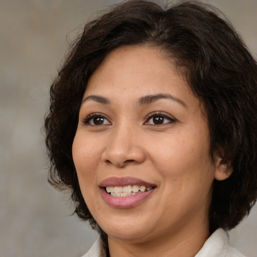Joyful white adult female with medium  brown hair and brown eyes