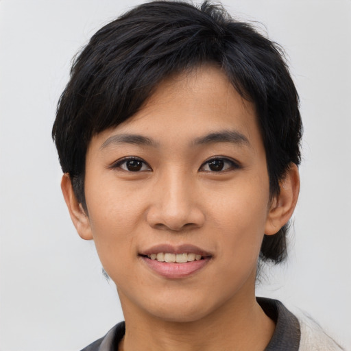 Joyful asian young-adult female with short  black hair and brown eyes