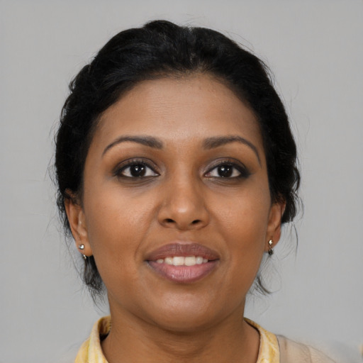 Joyful black young-adult female with medium  brown hair and brown eyes