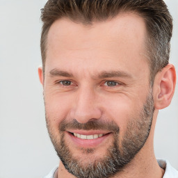 Joyful white adult male with short  brown hair and brown eyes