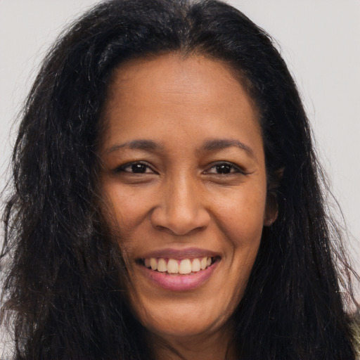 Joyful latino young-adult female with long  brown hair and brown eyes
