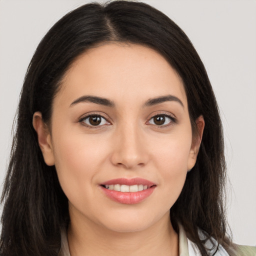 Joyful white young-adult female with long  brown hair and brown eyes