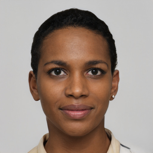 Joyful black young-adult female with short  black hair and brown eyes