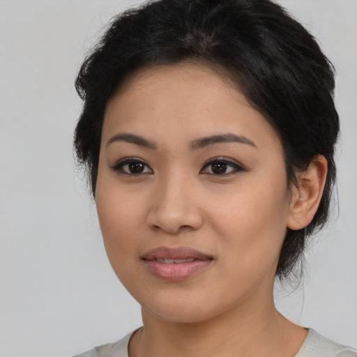 Joyful latino young-adult female with medium  black hair and brown eyes