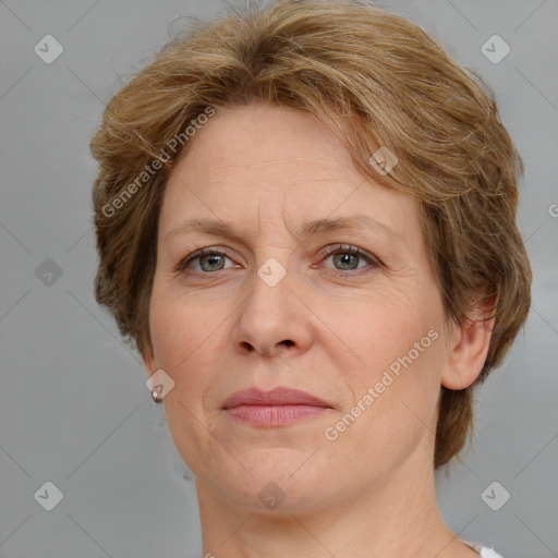 Joyful white adult female with medium  brown hair and grey eyes