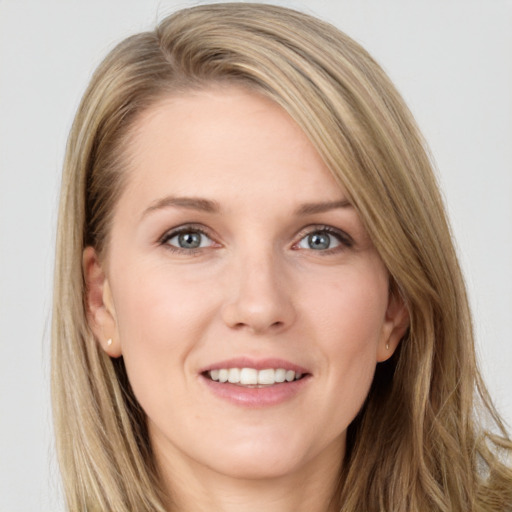 Joyful white young-adult female with long  brown hair and grey eyes