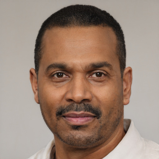Neutral latino adult male with short  black hair and brown eyes