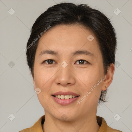 Joyful asian young-adult female with medium  brown hair and brown eyes