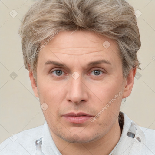 Neutral white adult male with short  brown hair and grey eyes