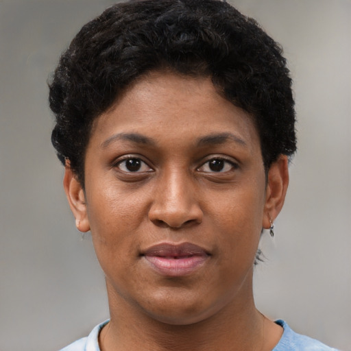 Joyful black young-adult female with short  brown hair and brown eyes
