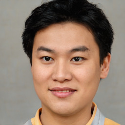 Joyful asian young-adult male with short  brown hair and brown eyes